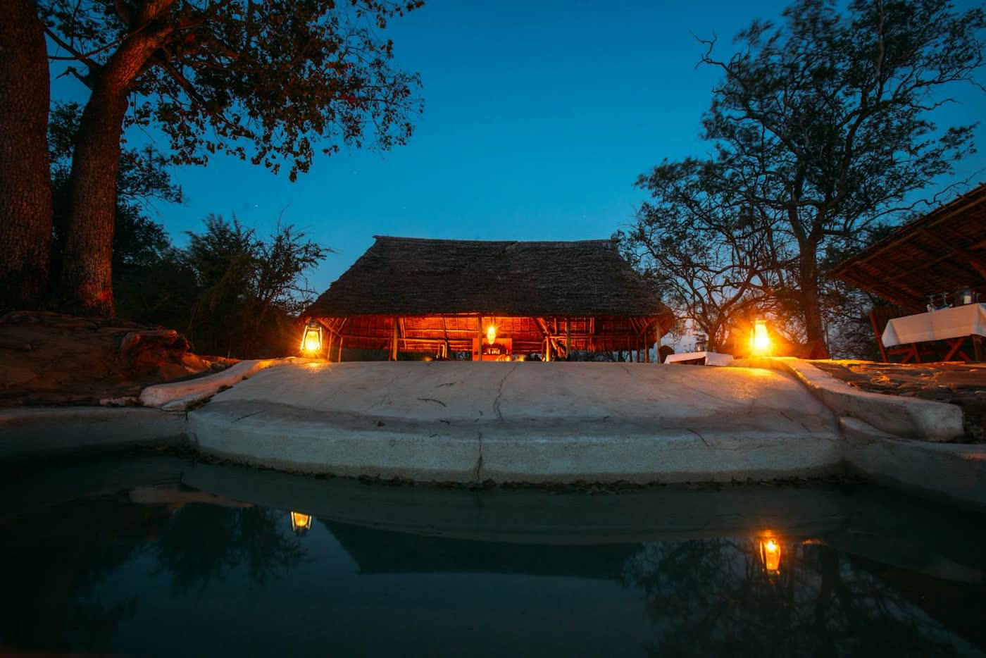 Safari lodge pool illuminated at dusk, Tanzania
